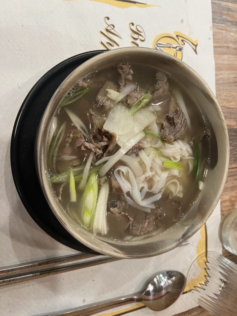 Bowl of Vietnamese pho with beef, rice noodles, and green onions at Fratelli Vietnam in Bologna