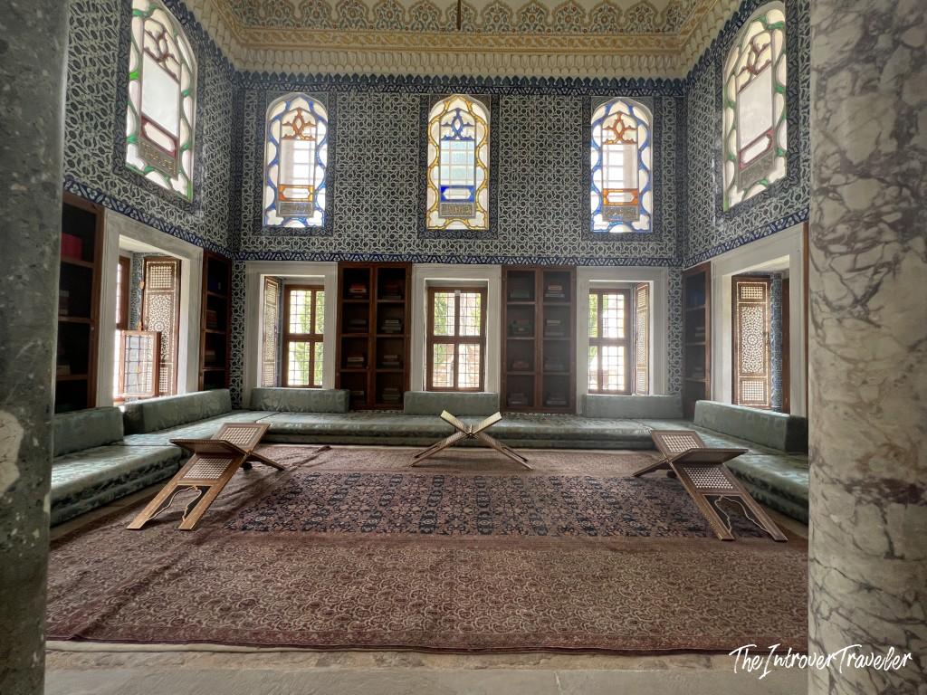 Interior of the Topkapi Palace Library, Istanbul, with Iznik-tiled walls and Quran stands on Persian carpet