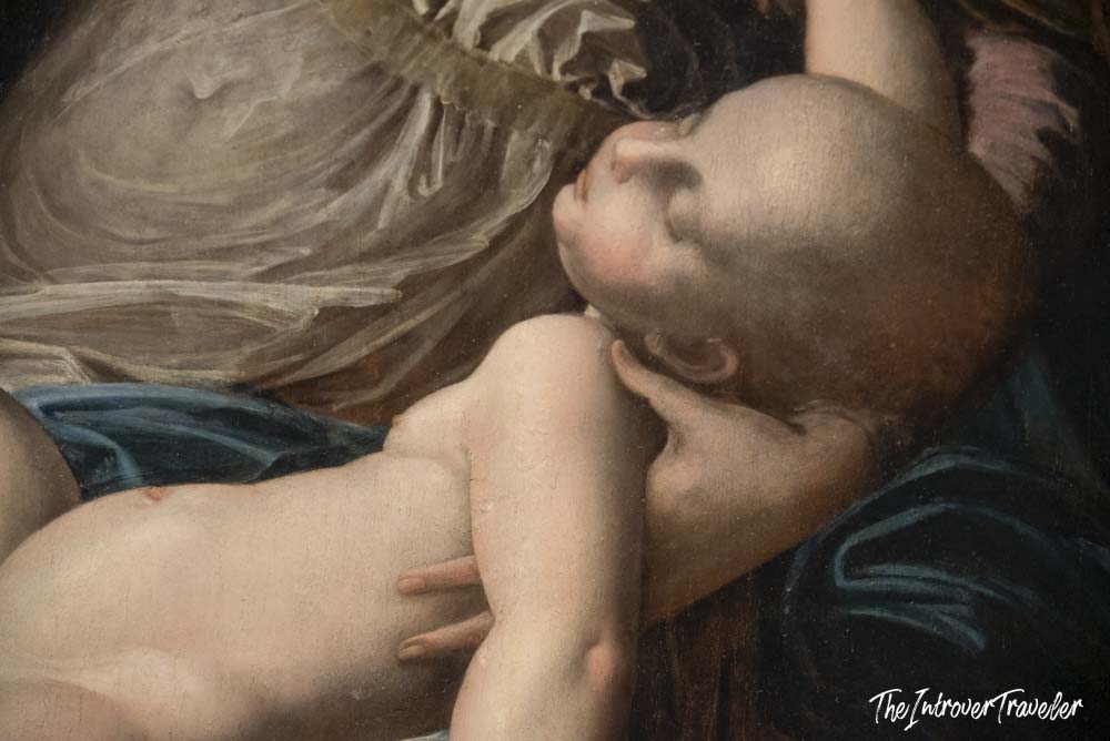 Close-up detail of the Christ Child in a Baroque painting at the Uffizi Gallery, Florence