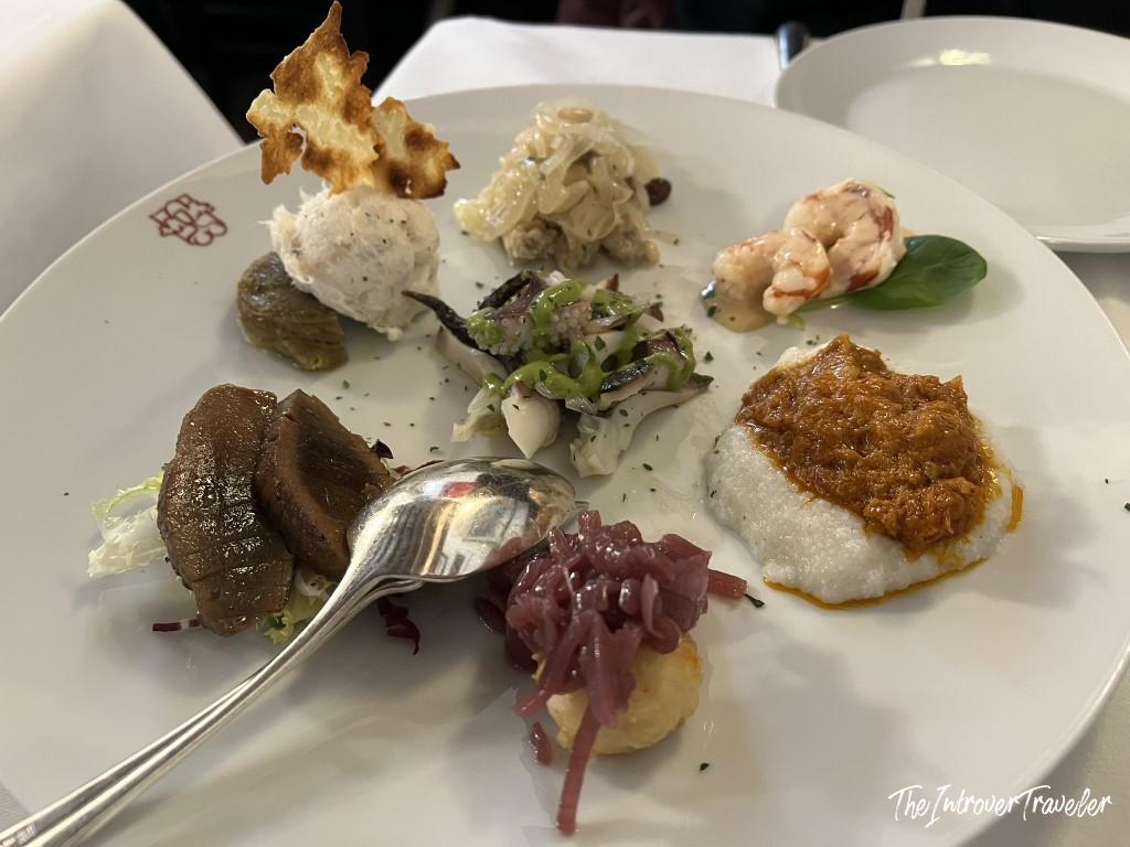 Antipasto misto di pesce at Le Antiche Carampane, Venice, featuring prawns, crab, and Adriatic seafood bites