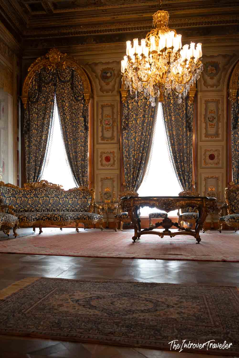 Ornate reception room in Dolmabahce Palace, Istanbul, with gilded baroque furniture and crystal chandelier