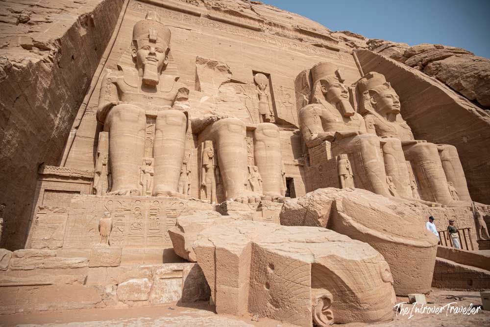 Four colossal seated statues of Ramesses II carved into the sandstone facade of Abu Simbel temple, Egypt
