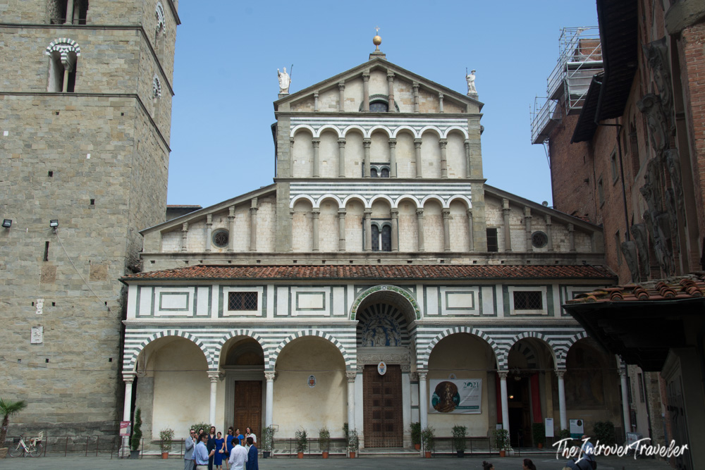 Pistoia Cathedral facade with green and white striped marble arches on Piazza del Duomo, Tuscany