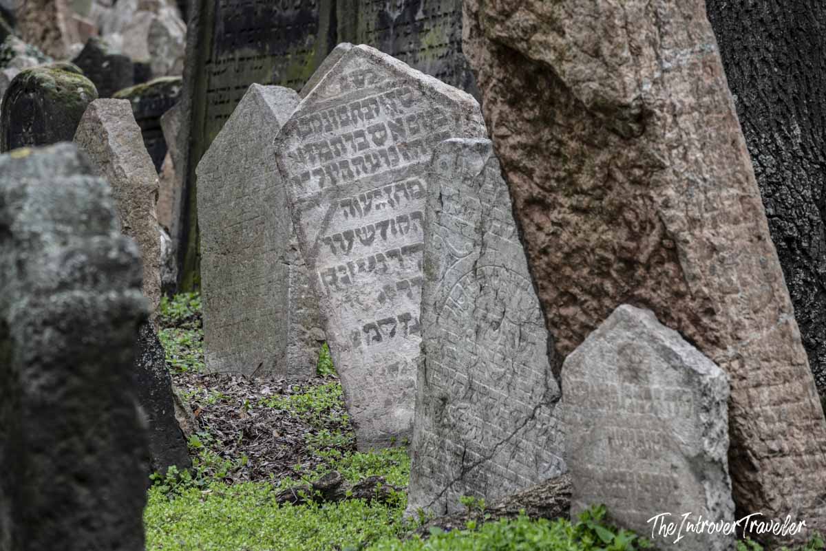 Crowded Hebrew-inscribed gravestones leaning at angles in the Old Jewish Cemetery, Prague
