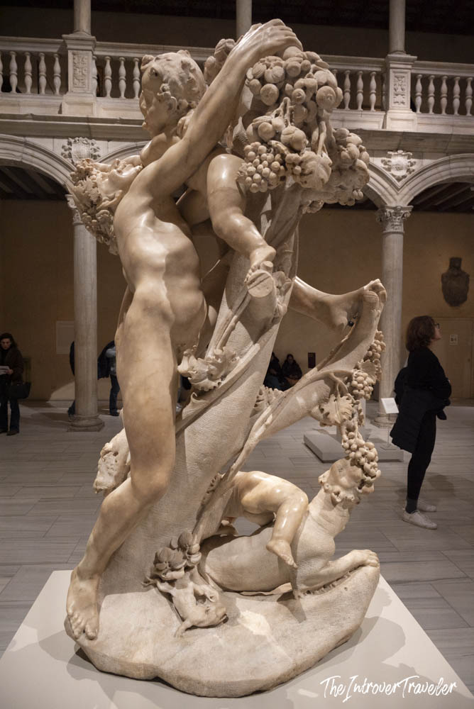 Baroque marble sculpture with figures and fruit garlands displayed in a grand gallery at the Met