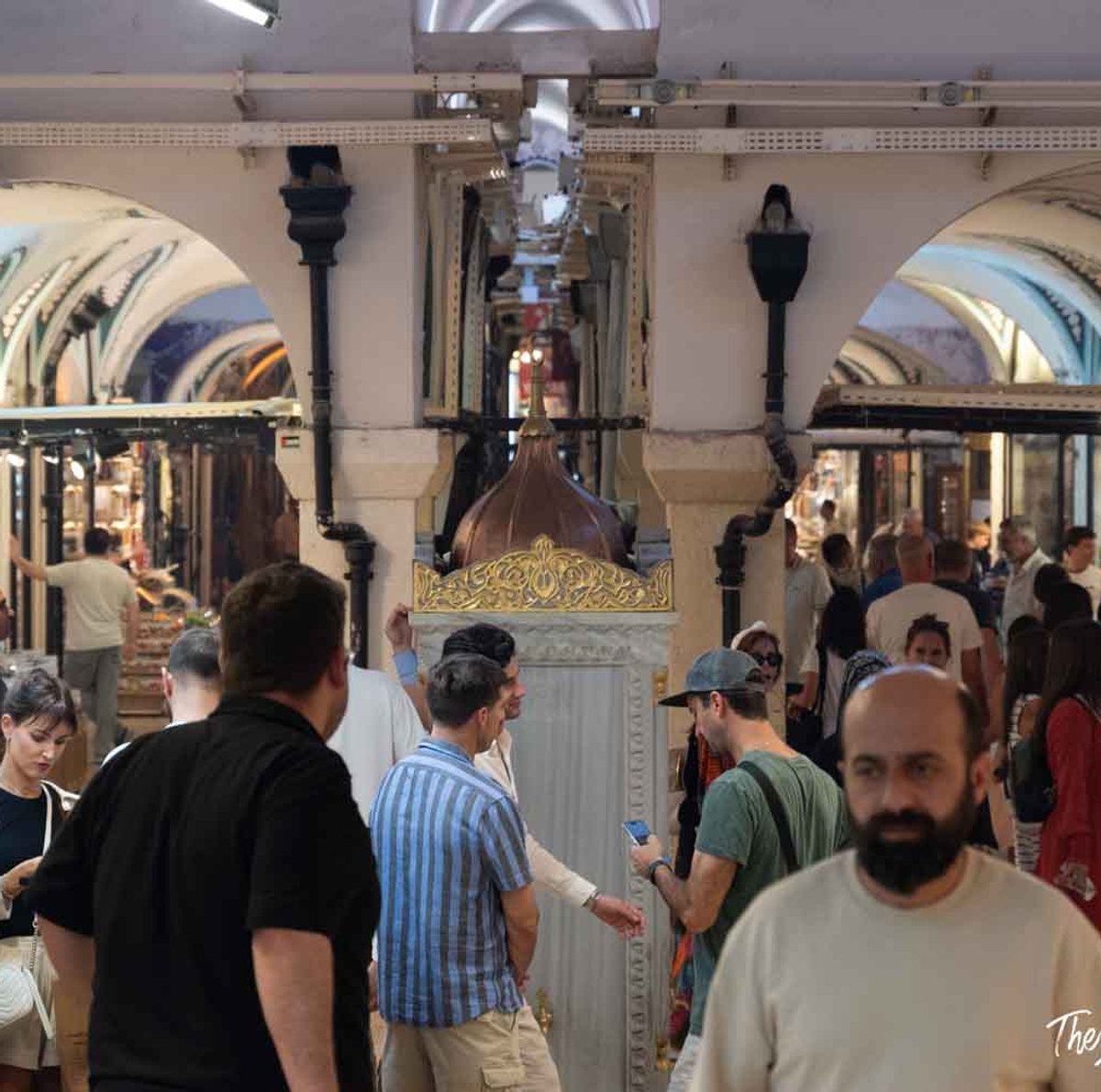 Crowds of visitors browsing the vaulted corridors of Istanbul's Grand Bazaar, one of the world's oldest covered markets
