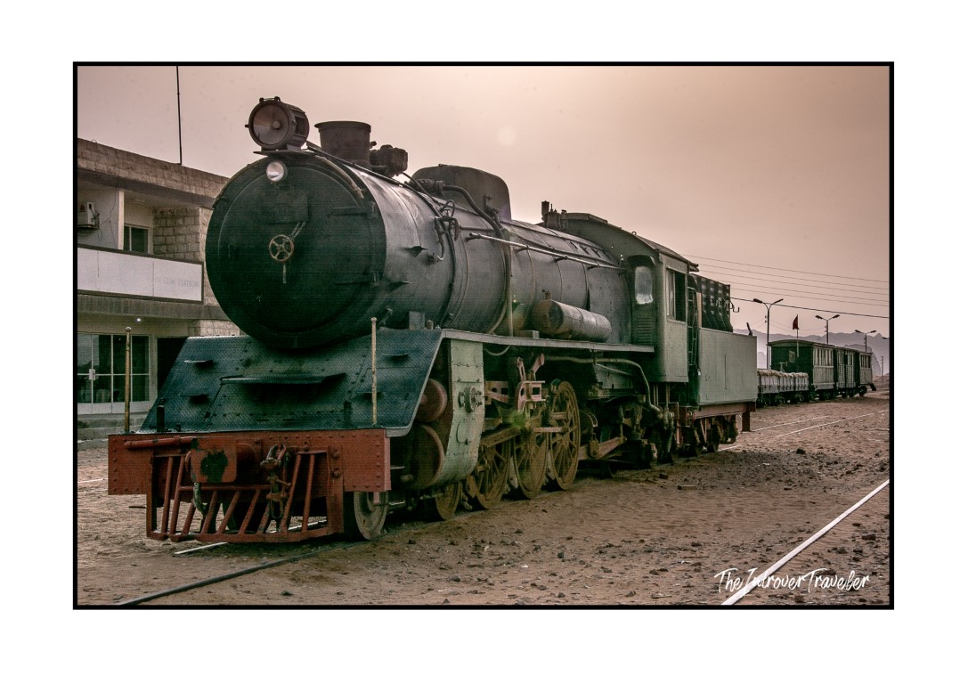 Vintage steam locomotive at a desert railway station near Wadi Rum, Jordan