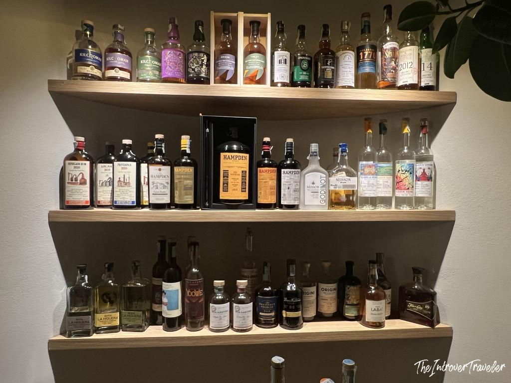Extensive spirits collection at Trattoria Da Lucio, featuring Hampden rum, Kilchoman whisky, and rare bottles