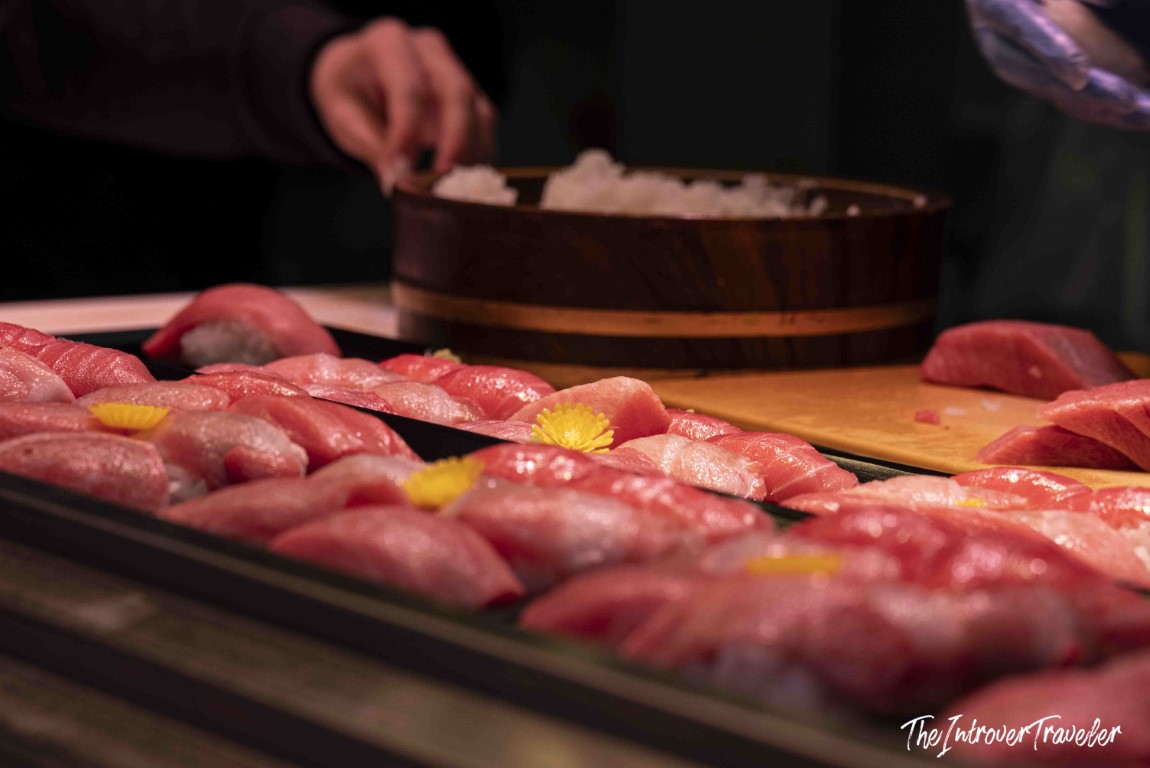 Rows of fresh tuna nigiri sushi being prepared at Tsukiji fish market, Tokyo