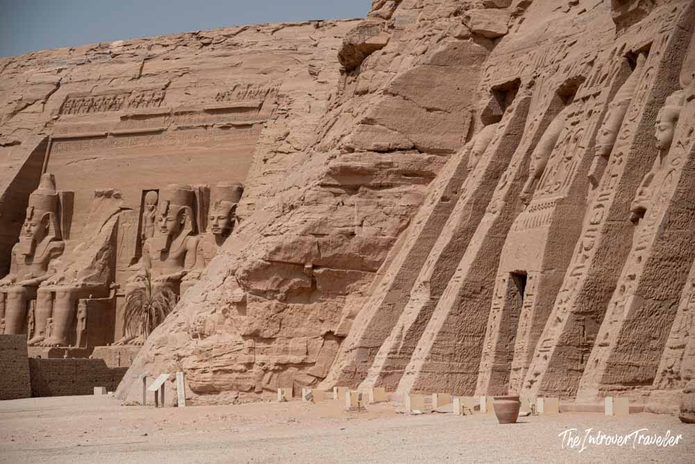 Both Abu Simbel temples carved into sandstone cliffs, showing Ramesses II colossi and Hathor temple facade