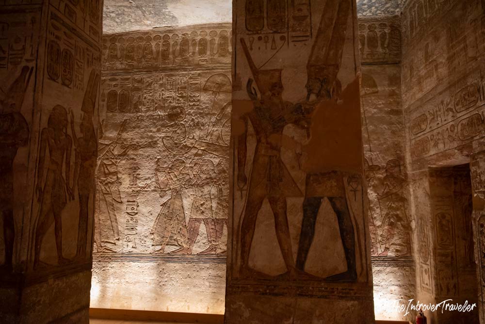 Interior pillars of Abu Simbel temple with carved relief scenes of Ramesses II and Egyptian gods
