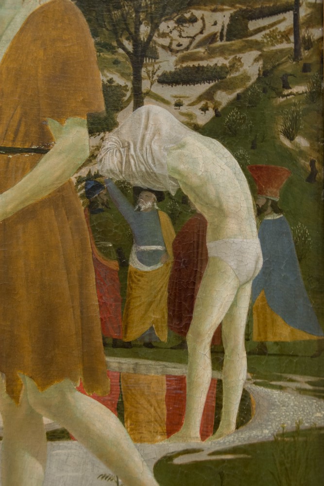 Detail of Baptism of Christ by Piero della Francesca, National Gallery London, showing a figure undressing