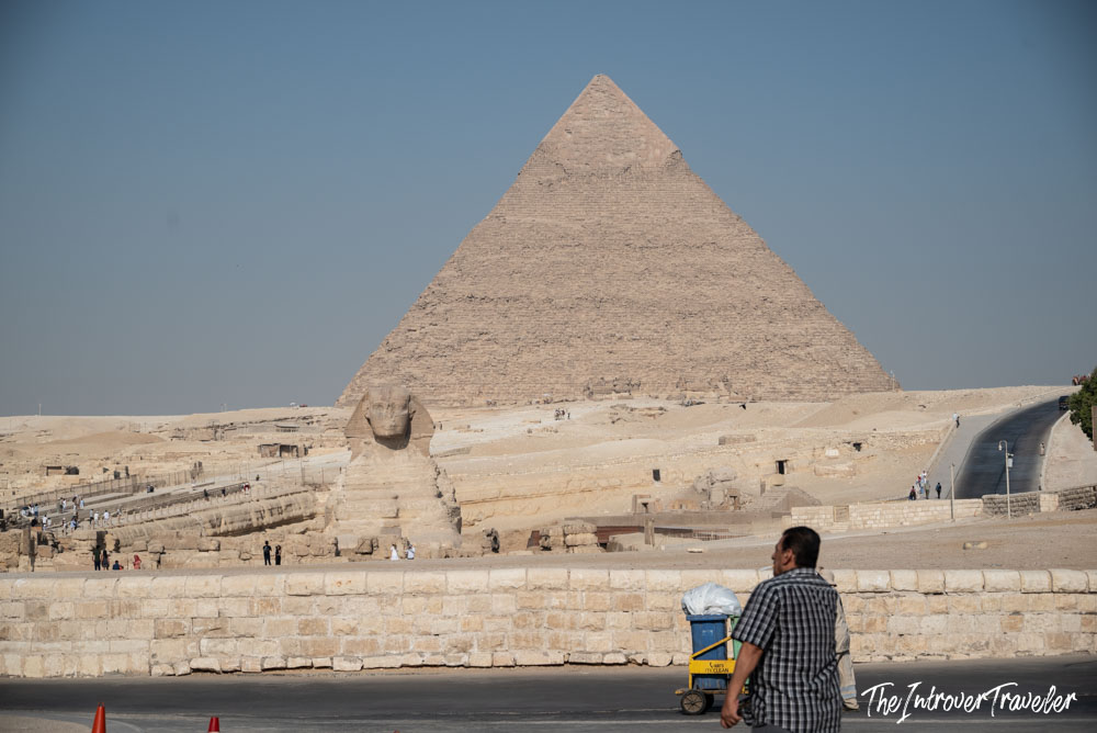 Great Sphinx and Pyramid of Khafre at Giza, with a local vendor in the foreground
