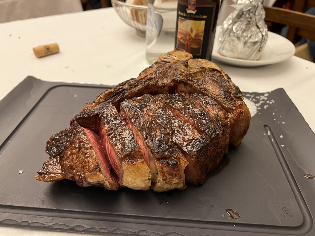 Bistecca alla Fiorentina at Trattoria Il Latini, sliced to reveal a rare pink center