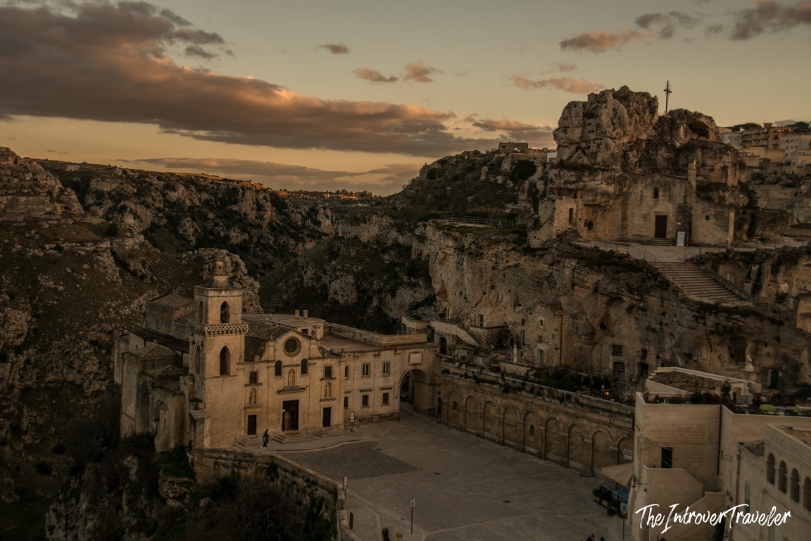 Chiesa di San Pietro Caveoso at sunset, with rocky ravine and cave dwellings of Matera, Italy