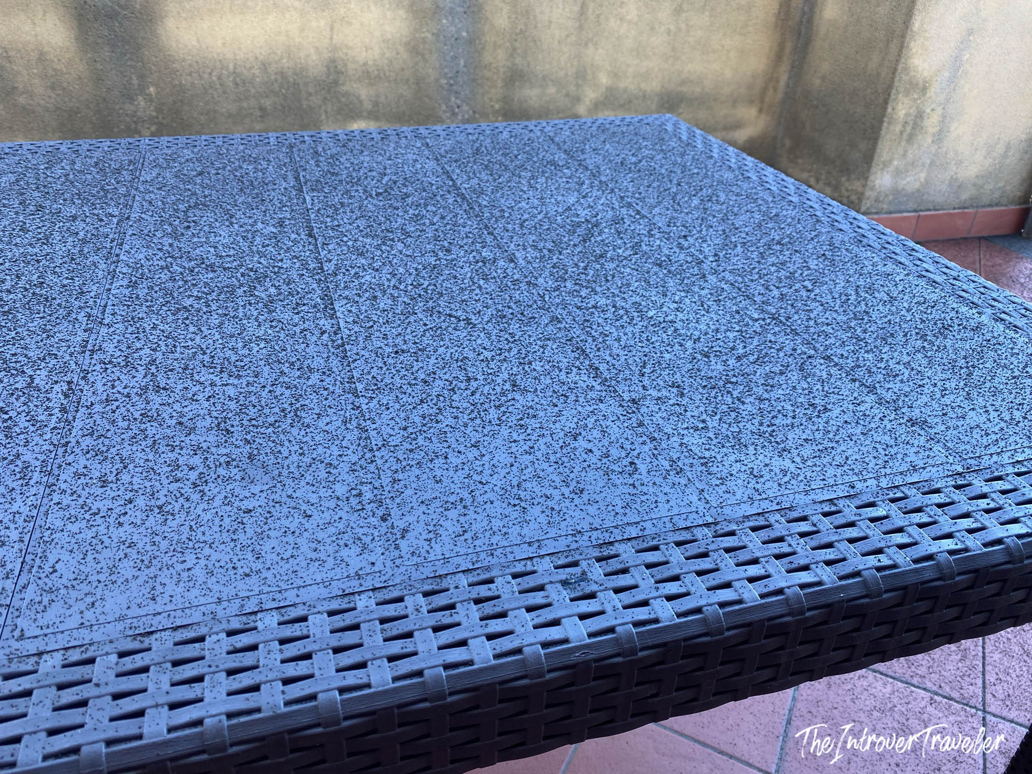 Outdoor table dusted with fine black volcanic ash from Mount Etna, Sicily