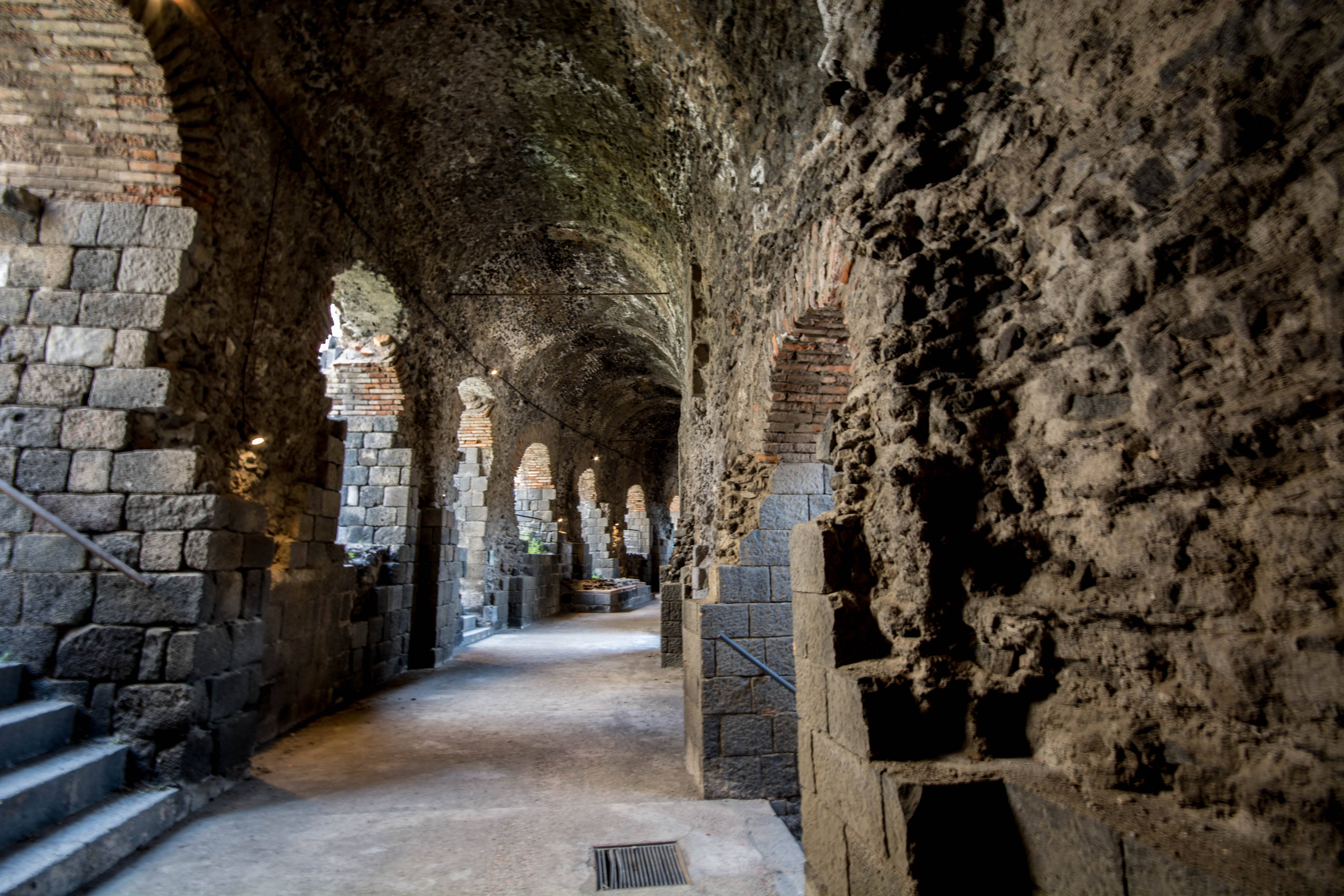 Underground Roman corridors of Catania amphitheater, built with volcanic lava stone and brick arches