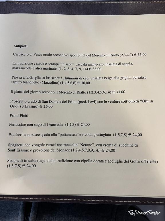 Le Antiche Carampane Venice menu showing seafood antipasti and primi piatti with prices