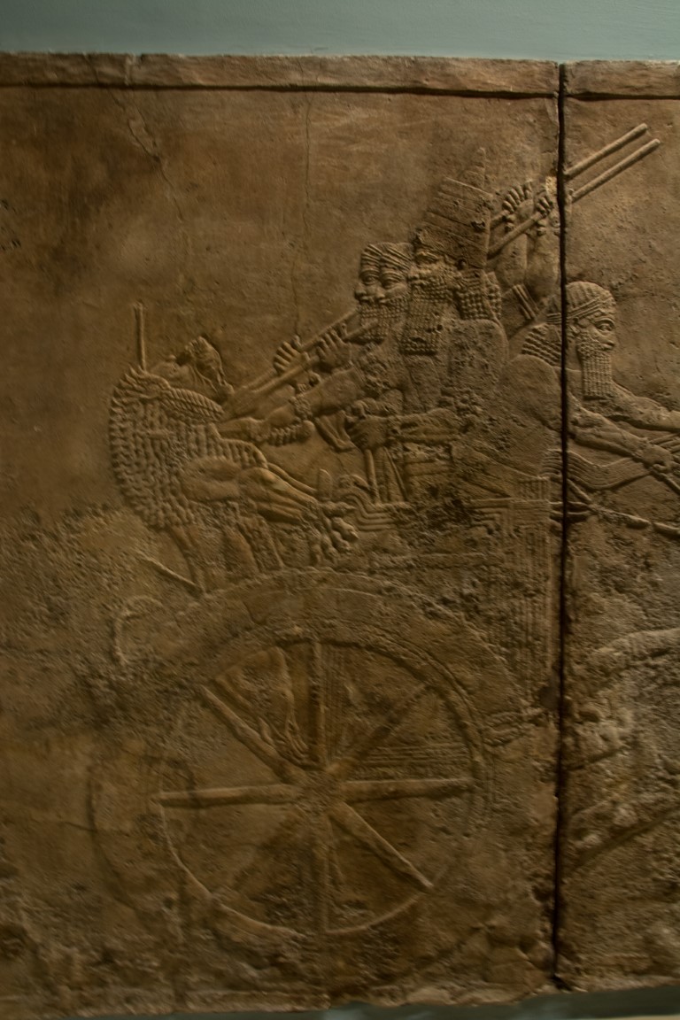 Assyrian stone relief depicting warriors on a chariot, British Museum London collection