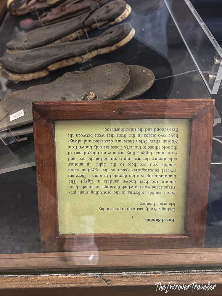 Ancient Egyptian leather eared sandals on display at the Egyptian Museum Cairo, with descriptive placard