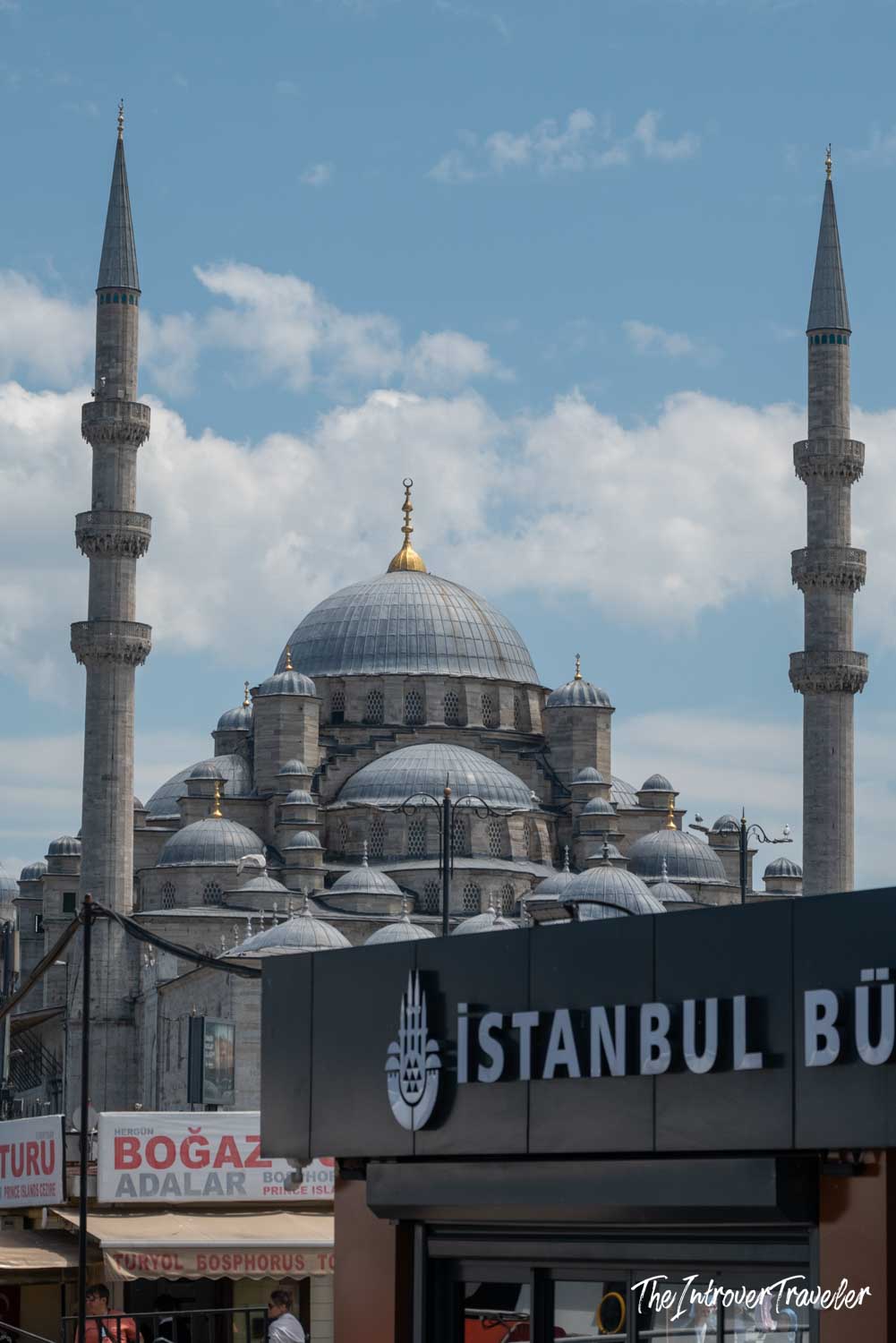 New Mosque (Yeni Cami) rising above Eminonu waterfront signs in Istanbul