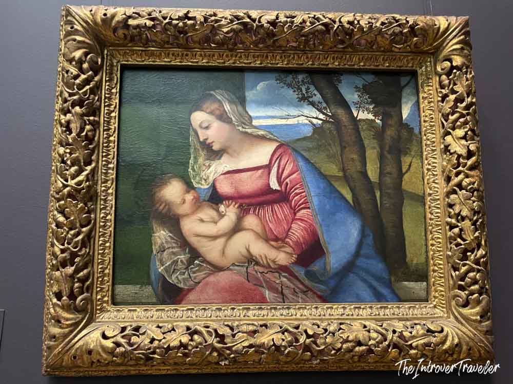 Madonna and Child painting by Titian in an ornate gilded frame at the Metropolitan Museum of Art