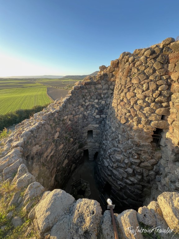 Aerial view into Su Nuraxi nuraghe corridor at Barumini, with Sardinian plains stretching beyond