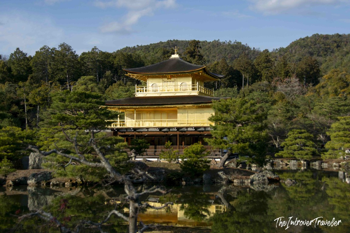 Kinkaku-ji Golden Pavilion reflected in Kyoko-chi pond, surrounded by pine trees in Kyoto