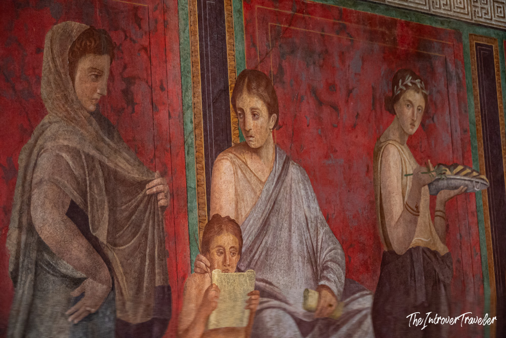 Ancient Roman fresco with female figures on red walls, Villa of the Mysteries, Pompeii