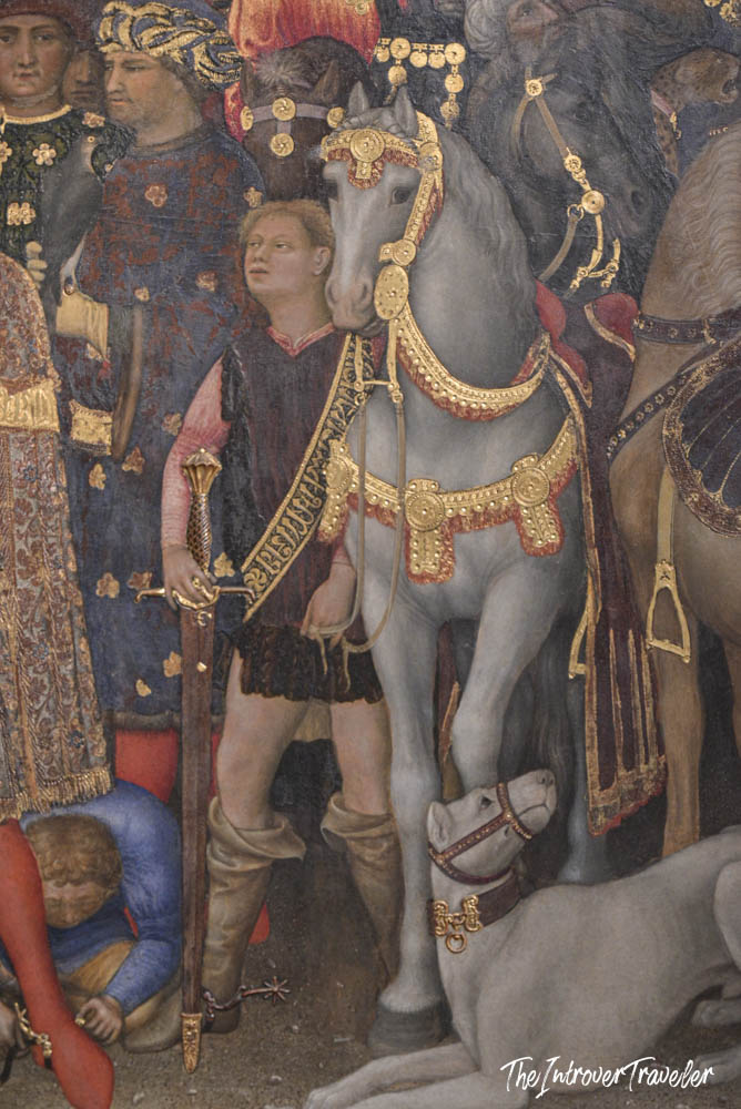 Detail of Gentile da Fabriano's Adoration of the Magi, showing a groom with ornate gold-bridled white horse at the Uffizi Gallery Florence