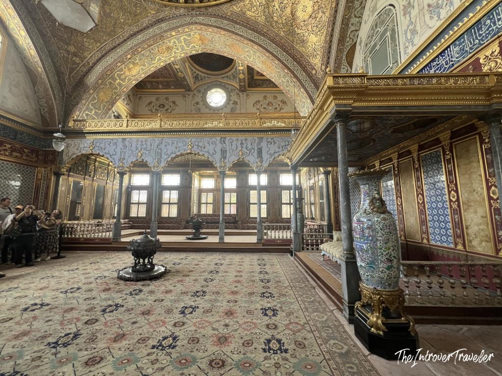 Imperial Hall of the Harem, Topkapi Palace, with gilded arches, Iznik tiles, and ornate carpets