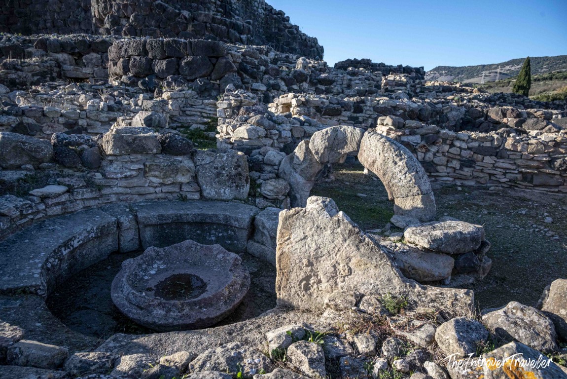 Stone ruins and ancient millstone at the Nuraghe of Barumini archaeological site, Sardinia