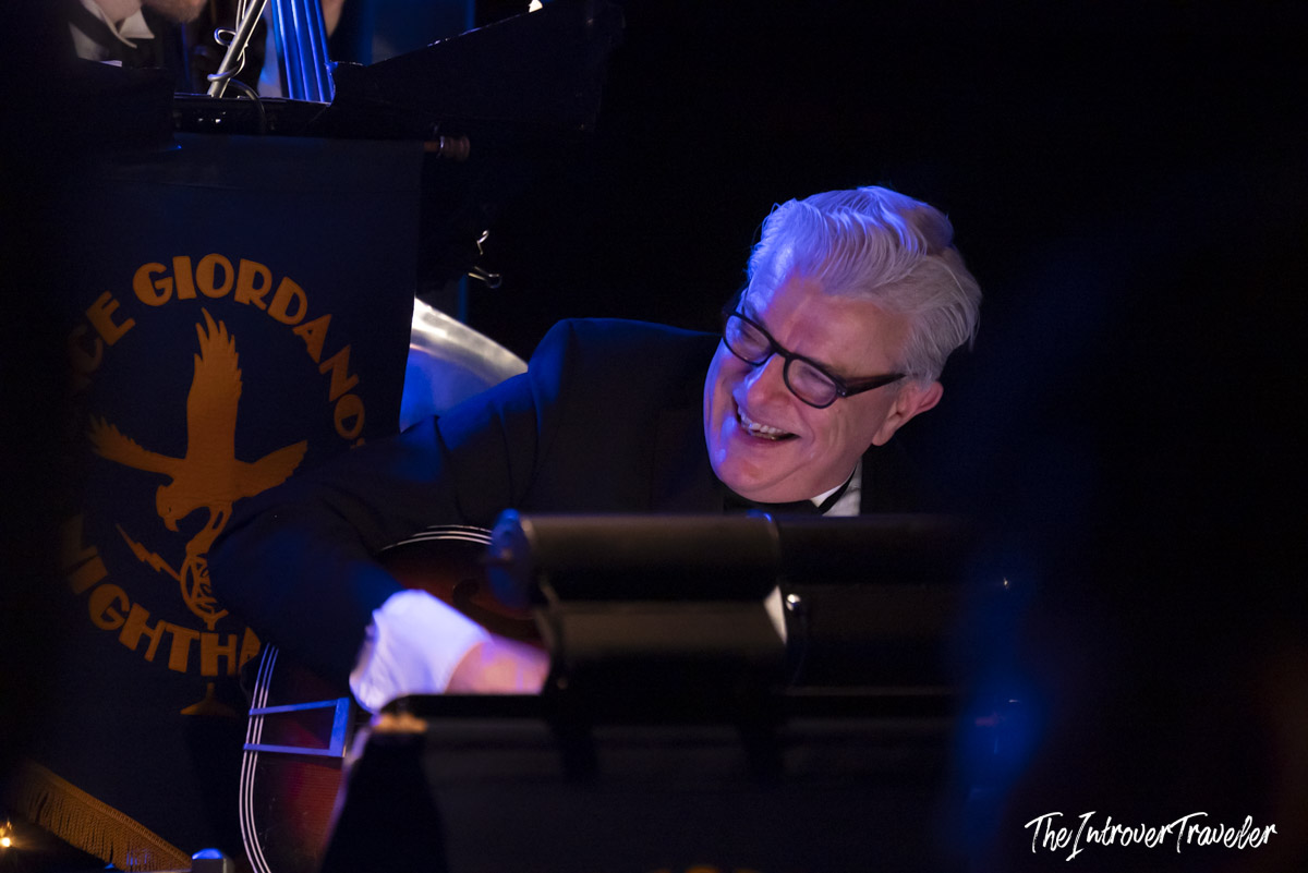 Smiling musician performing with Vince Giordano and the Nighthawks at Birdland jazz club, New York