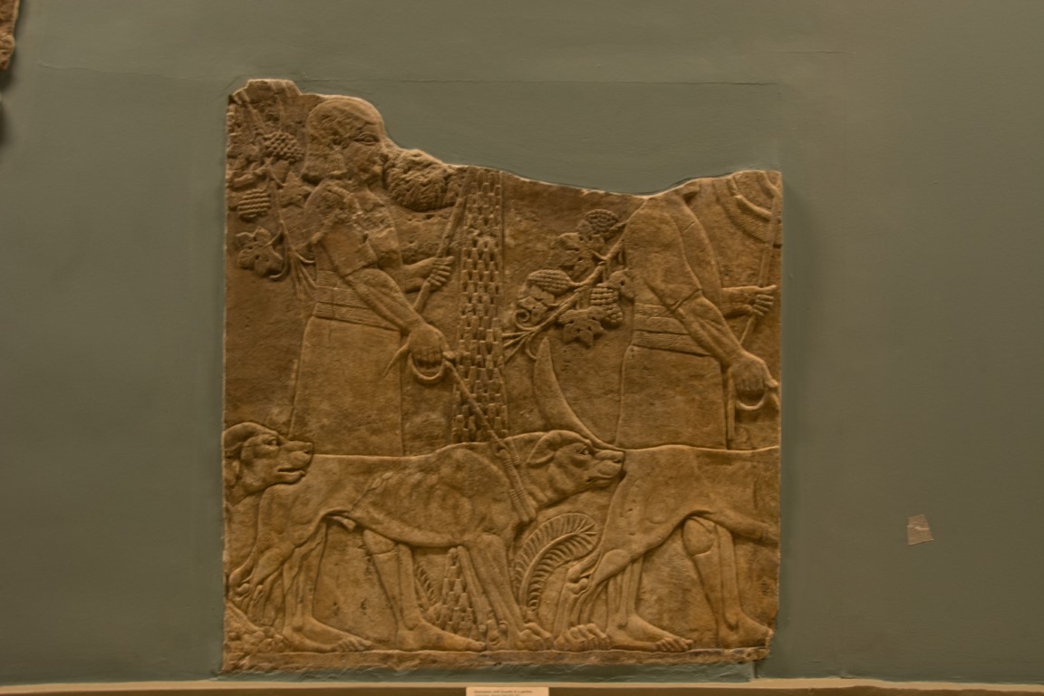 Assyrian stone relief with huntsmen and dogs, British Museum London collection