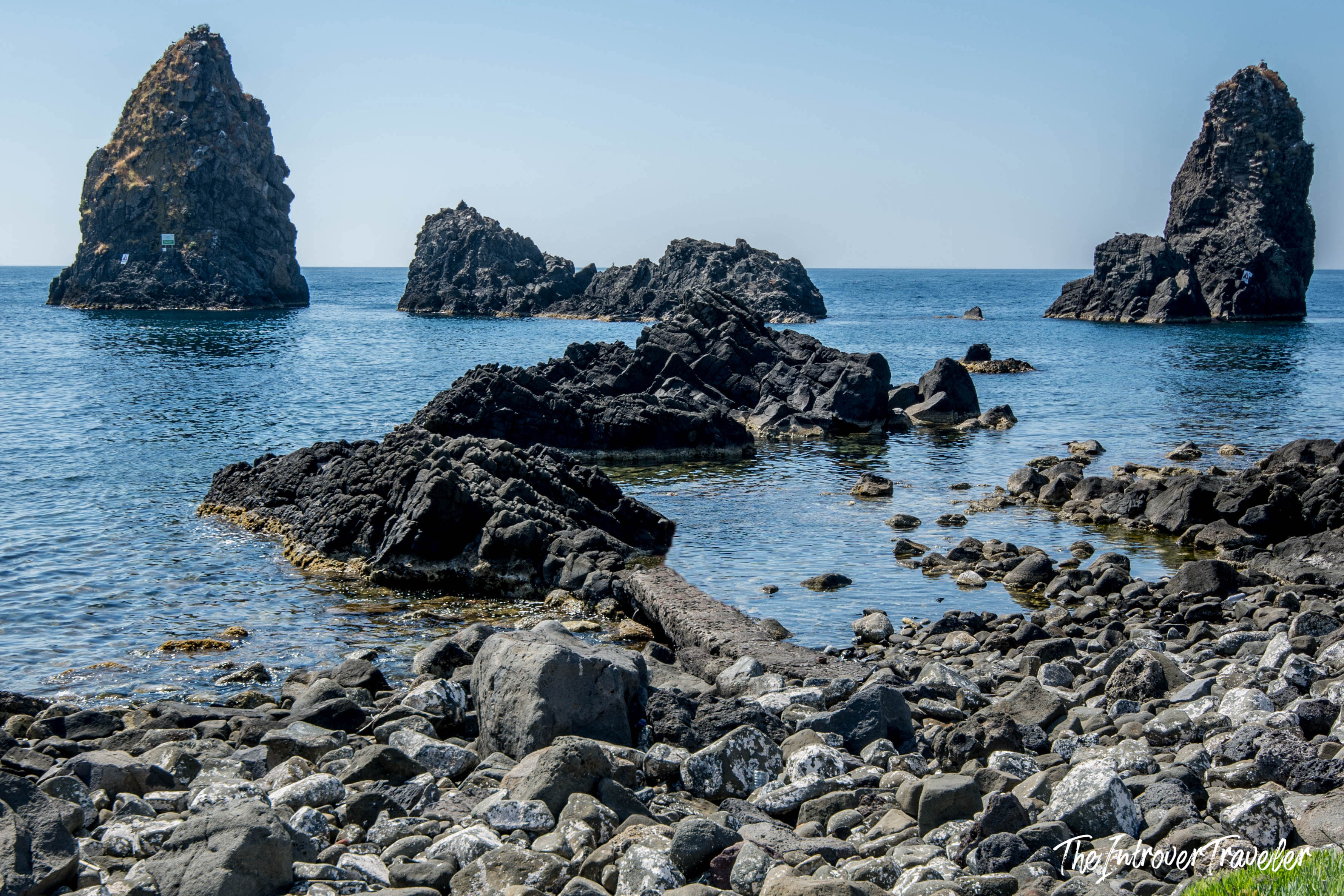 Faraglioni di Aci Trezza, the legendary volcanic sea stacks off the Sicilian coast near Catania