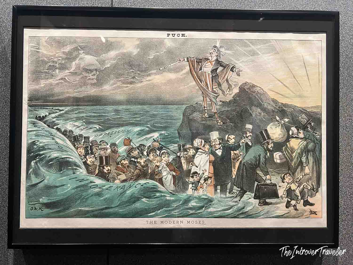 Puck magazine cartoon "The Modern Moses," depicting immigrants fleeing oppression and intolerance toward America