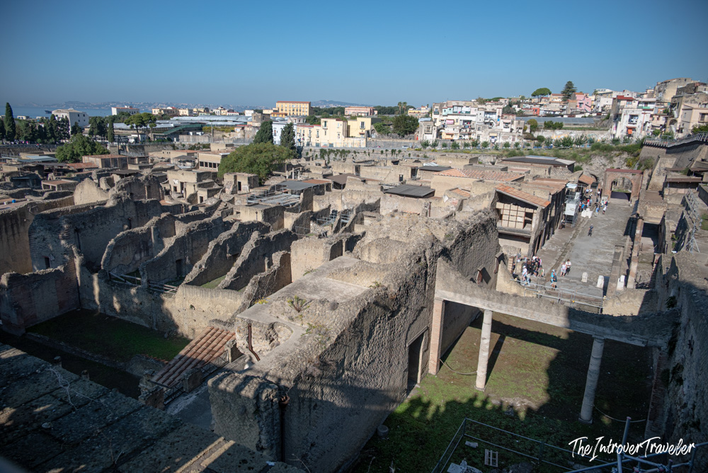 Aerial view of Herculaneum excavations, ancient Roman ruins surrounded by modern Ercolano cityscape