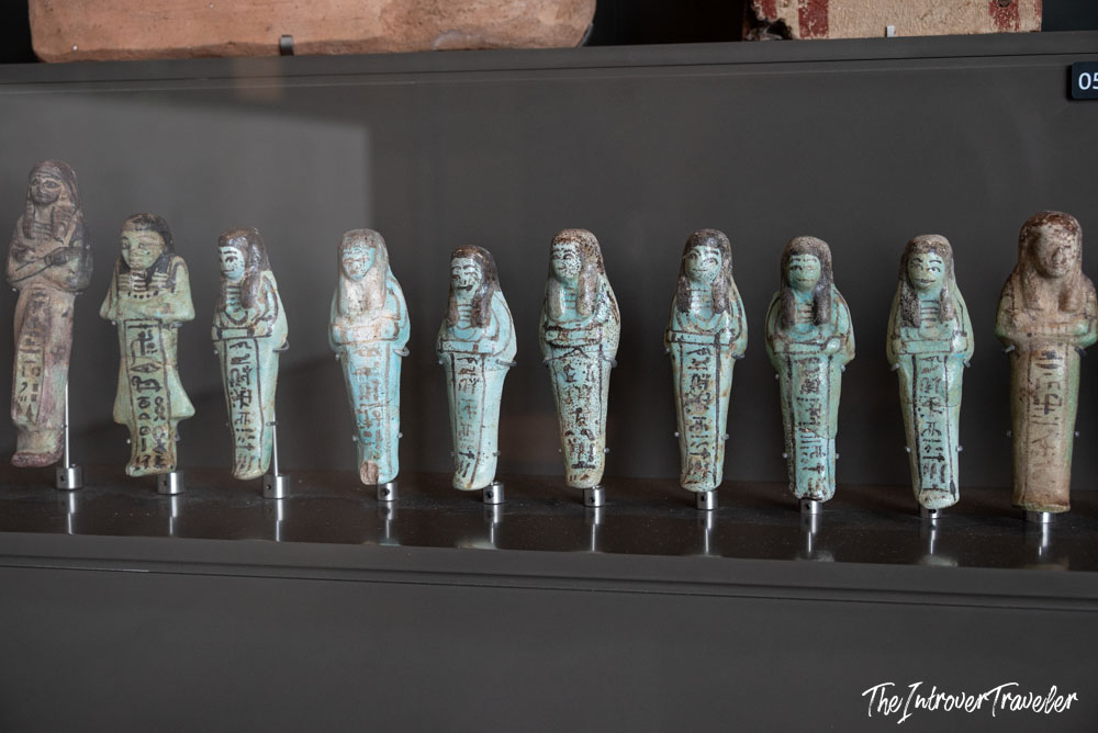 Row of ancient Egyptian faience ushabti figurines on display at the Grand Egyptian Museum in Cairo