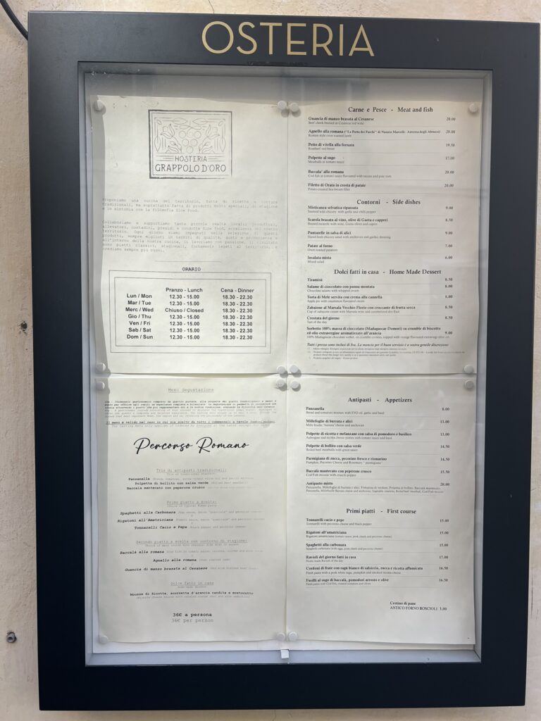 Outdoor menu board of Hosteria Grappolo d'Oro in Rome, showing Roman dishes and opening hours