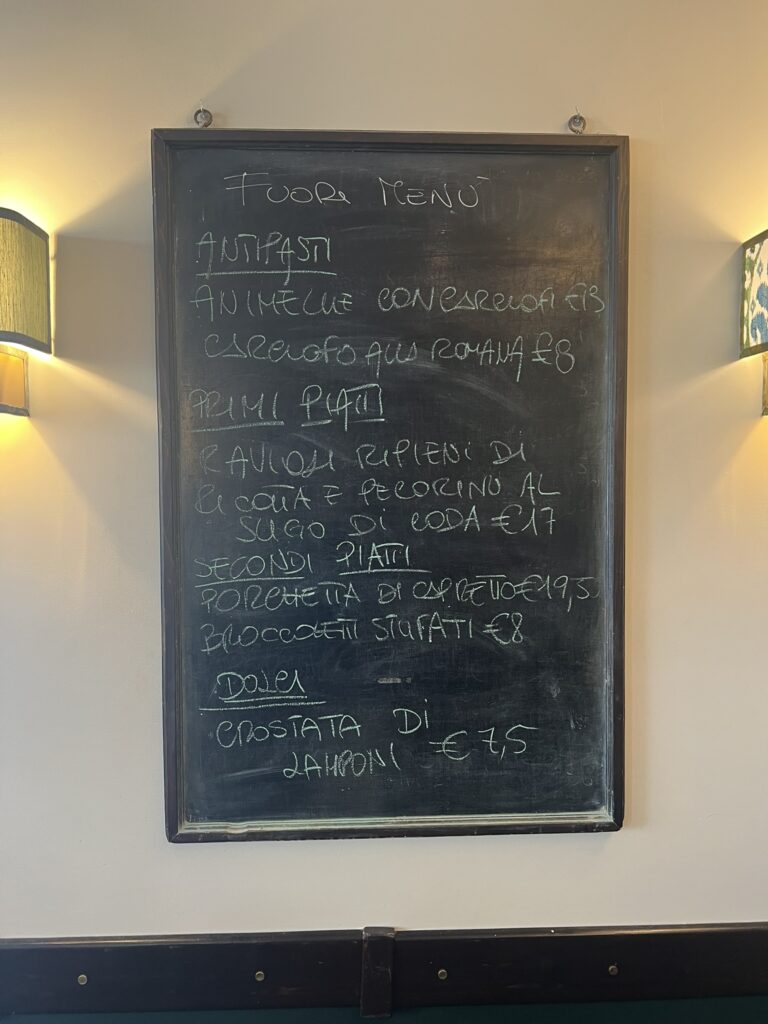 Chalkboard fuori menu at Grappolo d'Oro, Rome, listing carciofo alla romana and porchetta di capretto