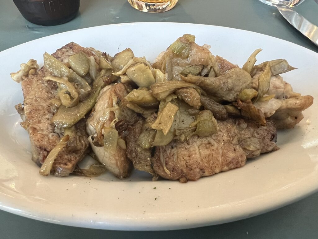 Saltimbocca alla Romana with sauteed artichokes served at Hosteria Grappolo d'Oro in Rome
