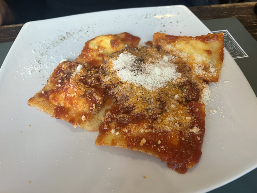Ravioli in tomato sauce topped with grated Parmesan at Hosteria Grappolo d'Oro, Rome