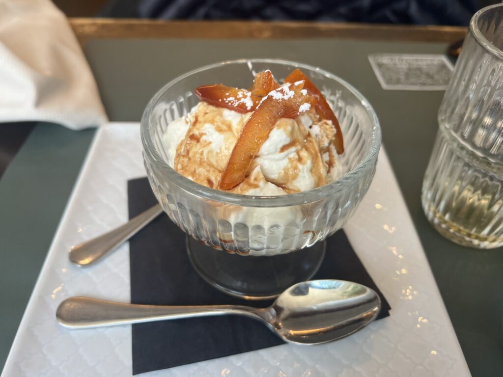 Ice cream sundae with caramelized fruit topping served at Hosteria Grappolo d'Oro, Rome