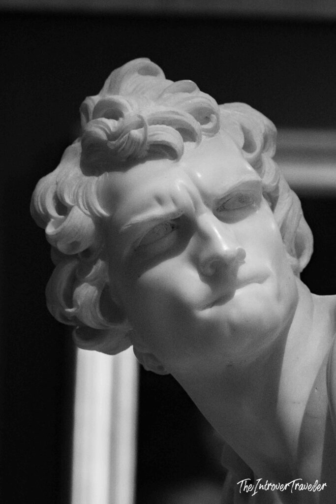 Close-up of Bernini's David marble bust, capturing his intense gaze at the Borghese Gallery in Rome