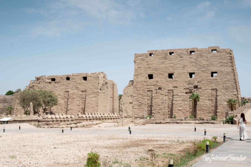 First pylon entrance gate of Karnak Temple Complex in Luxor, with the Avenue of Sphinxes visible alongside