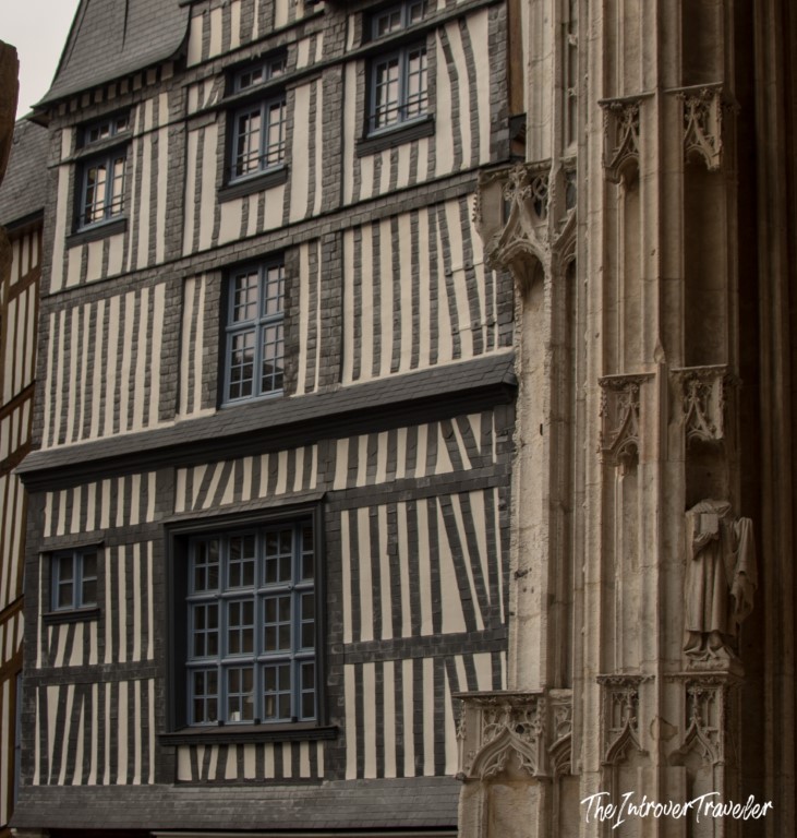 Medieval half-timbered facade beside Gothic stonework of Rouen Cathedral, Normandy, France