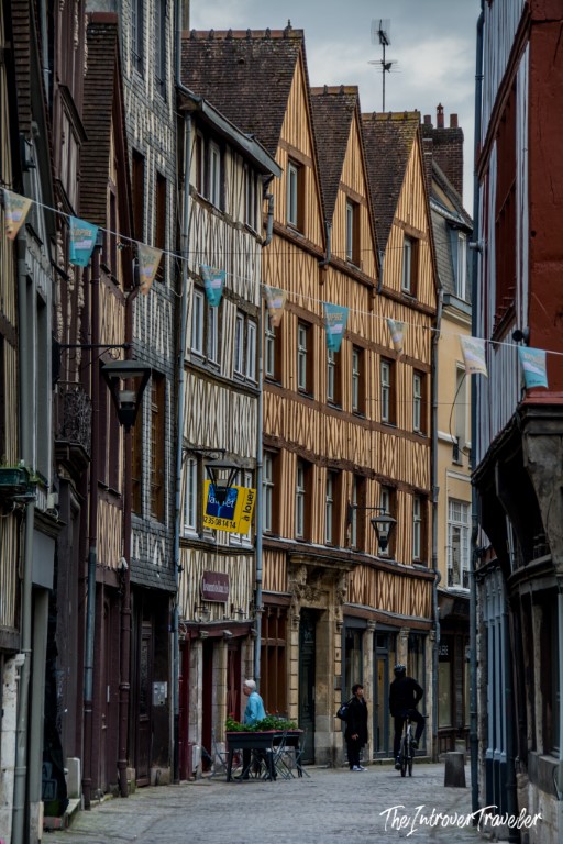 Narrow cobblestone street in Rouen lined with medieval half-timbered facades, Normandy France