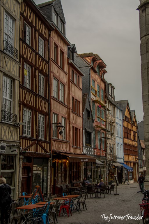 Colourful medieval half-timbered buildings lining a cobblestone street in Rouen, Normandy