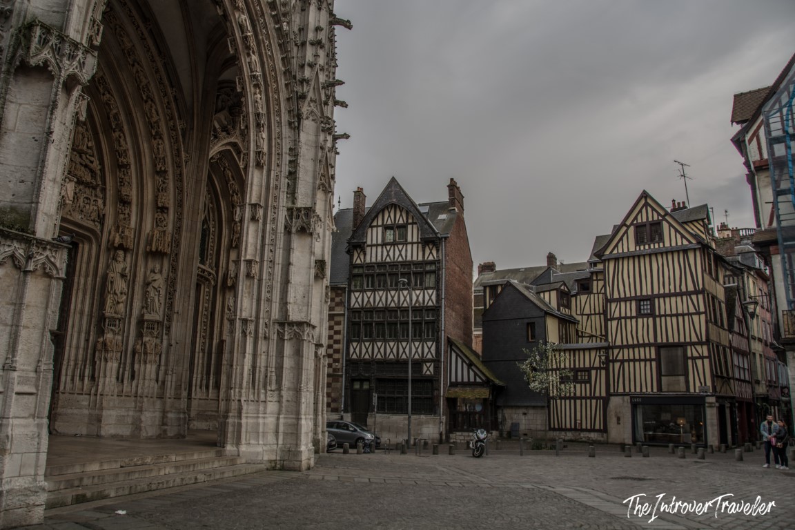 Gothic portal of Saint-Maclou Church beside medieval half-timbered houses in Rouen, Normandy