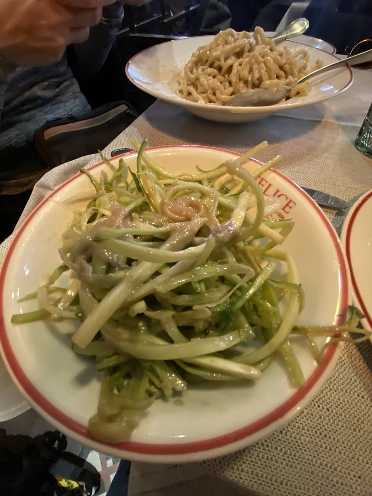 Shredded zucchini salad at Felice a Testaccio, Rome, with cacio e pepe pasta in the background